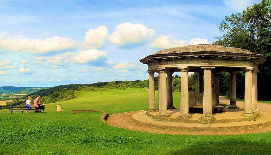 A gazebo sits on top of a grassy hill.