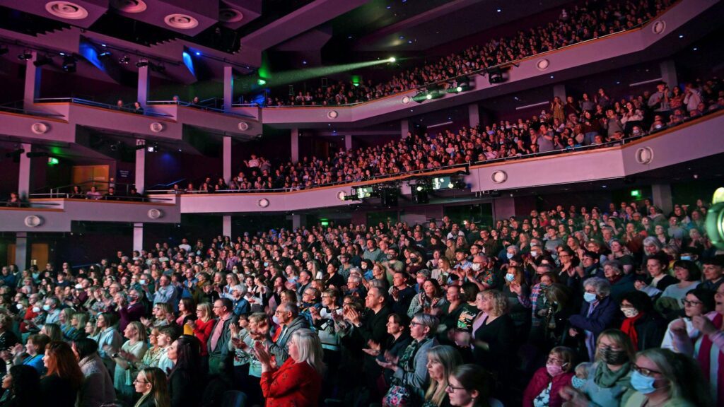 An auditorium full of people watching a performance.