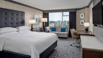 ![A hotel room with a large bed and a television.