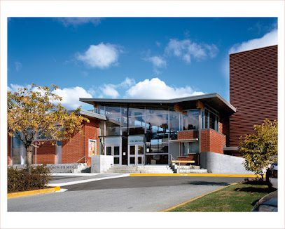 ![The exterior of a brick building with a glass roof.