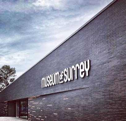 ![A black building with the word museum surrey on it.
