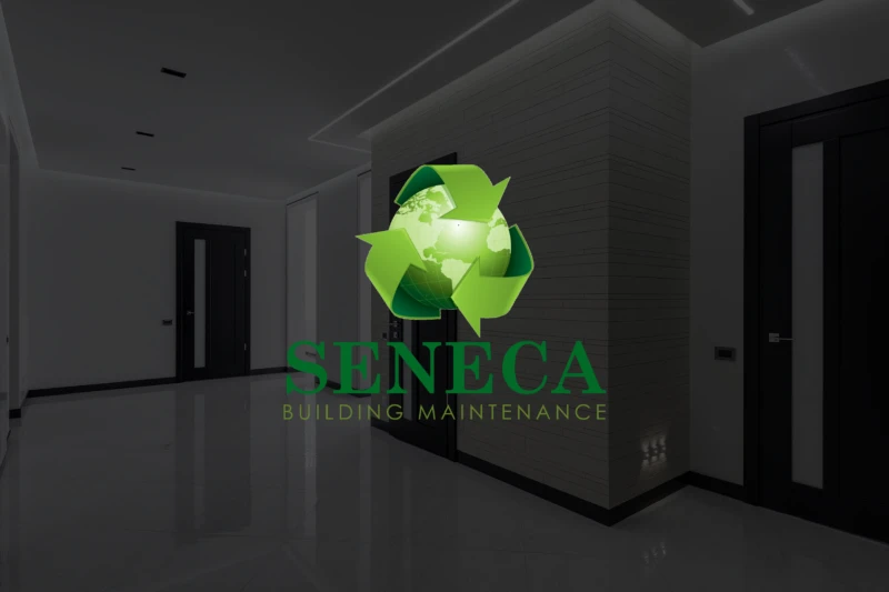 Sleek hallway in a modern building with shiny black floor and white walls, featuring the green Seneca Building Maintenance logo with a recycling symbol.