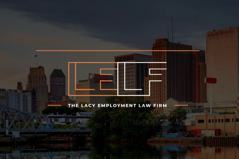 Logo of The Lacy Employment Law Firm superimposed on a cityscape at dusk with buildings and a bridge in the background.